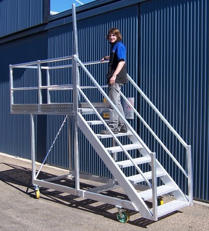 A mobile cantilevered stair access platform to reach over dozer caterpillar tracks